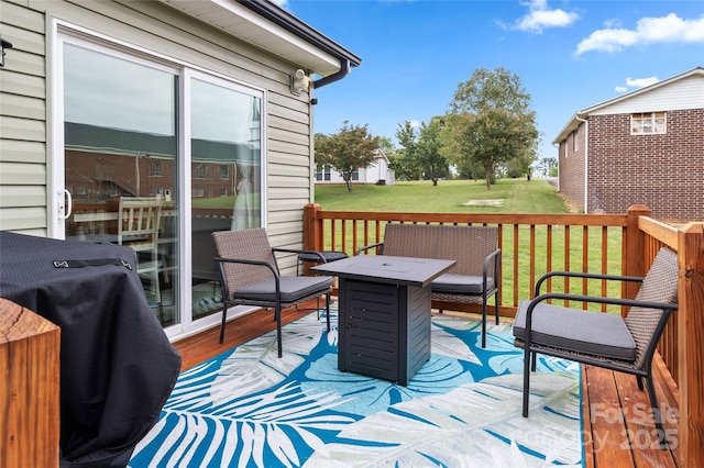 wooden terrace with area for grilling and a lawn