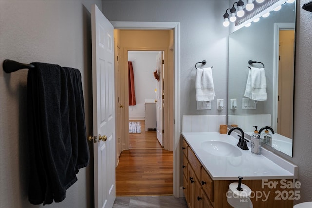 bathroom featuring hardwood / wood-style flooring and vanity