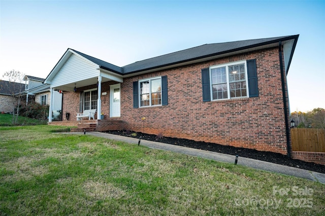 single story home featuring a porch and a front lawn