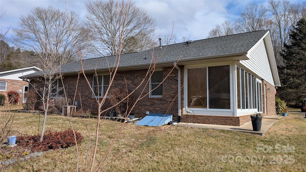 rear view of property with a yard