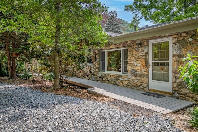 view of exterior entry featuring a deck