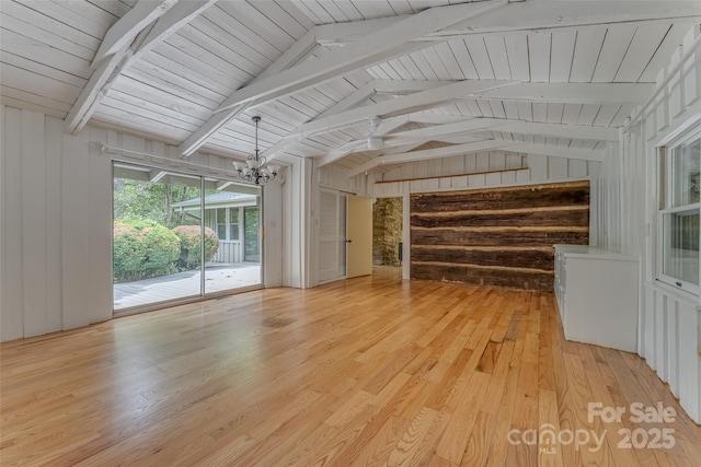 unfurnished sunroom featuring lofted ceiling with beams and a notable chandelier