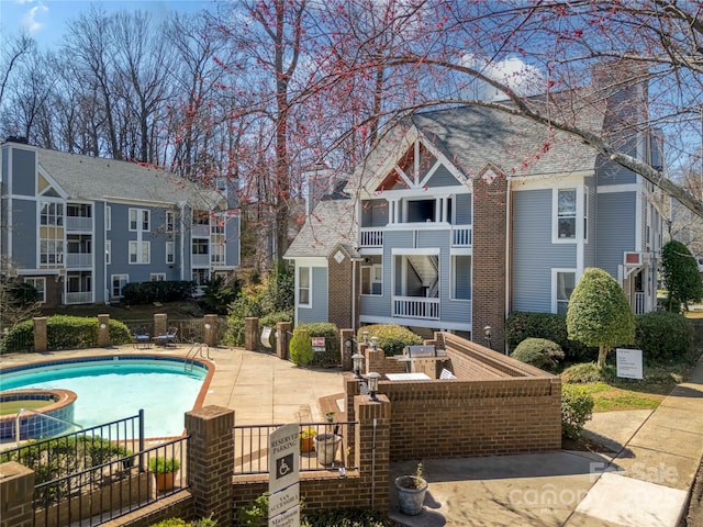 pool featuring a patio area and a residential view