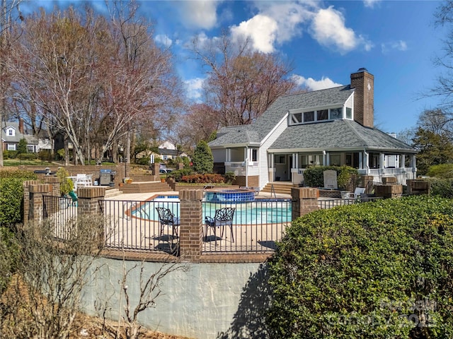 community pool featuring a patio and fence