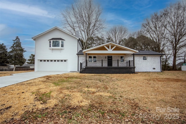 view of front facade with a garage, covered porch, and a front lawn