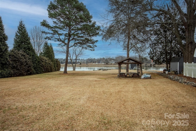 view of yard featuring a water view and a gazebo