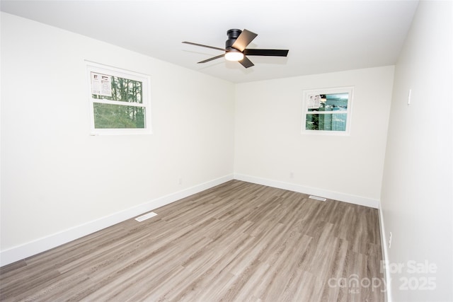 empty room with ceiling fan and light wood-type flooring