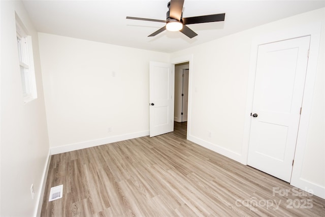 unfurnished bedroom with ceiling fan and light wood-type flooring