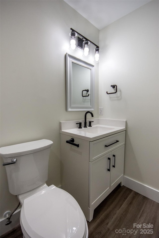 bathroom featuring hardwood / wood-style floors, toilet, and vanity