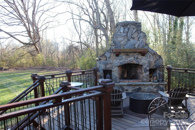 wooden terrace with an outdoor stone fireplace