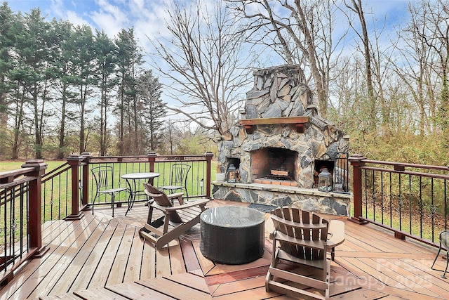 wooden terrace with an outdoor stone fireplace