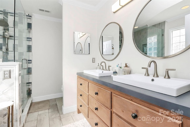 bathroom with vanity, crown molding, and walk in shower