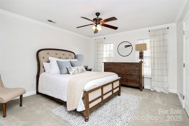 carpeted bedroom with ornamental molding and ceiling fan