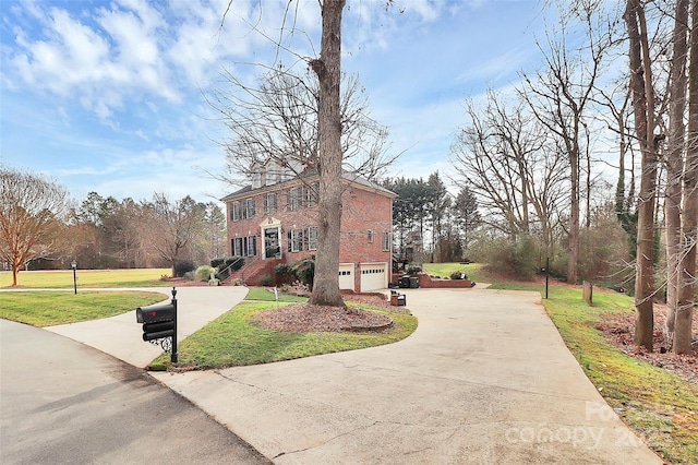 view of property exterior with a garage and a lawn