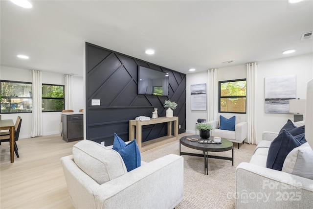 living room featuring light hardwood / wood-style floors and a healthy amount of sunlight