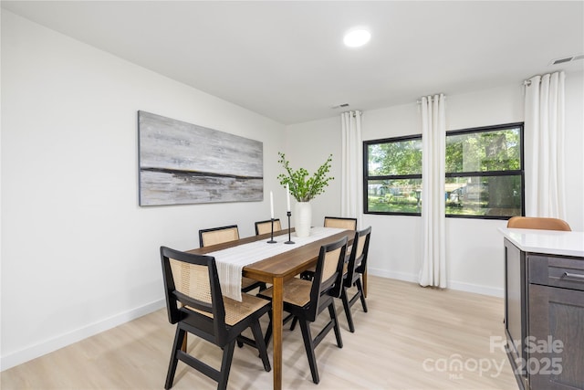 dining area with light hardwood / wood-style flooring