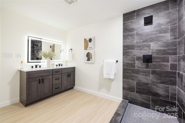 bathroom with vanity and hardwood / wood-style flooring