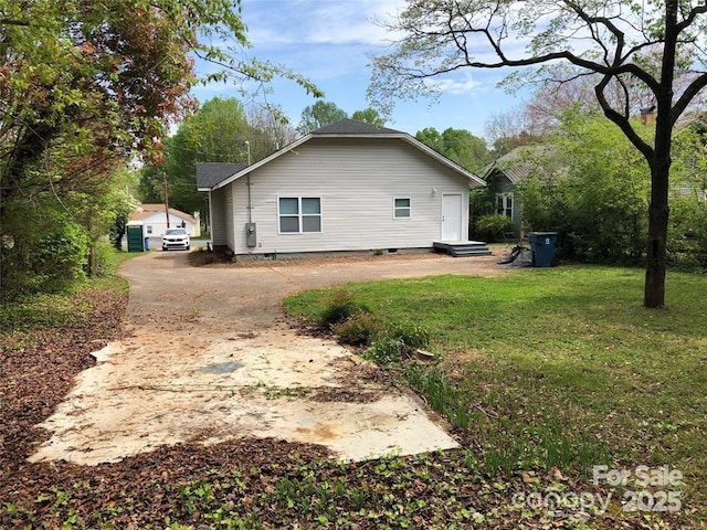 view of side of property with a yard