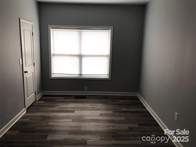 unfurnished room with dark hardwood / wood-style floors