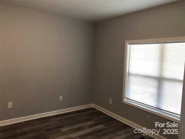 empty room featuring dark hardwood / wood-style flooring