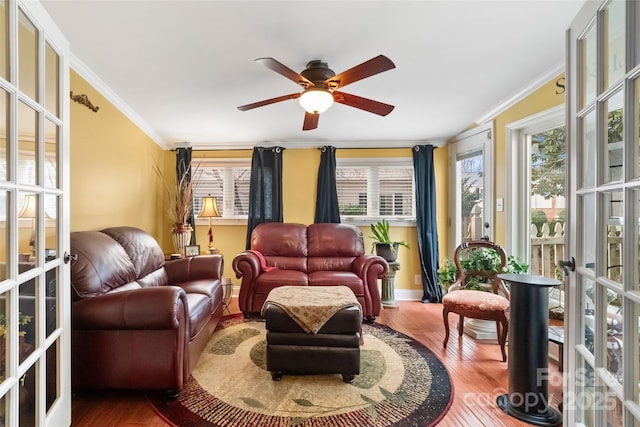 living room featuring hardwood / wood-style flooring, french doors, and ornamental molding