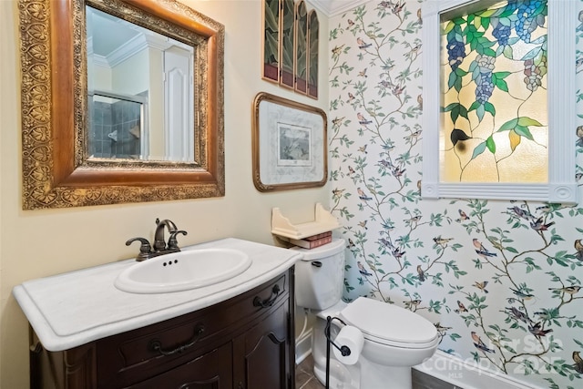 bathroom with vanity, toilet, and crown molding