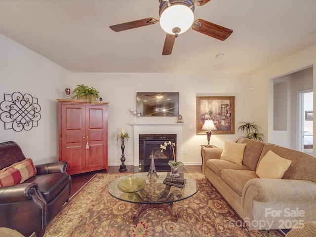 living room featuring wood-type flooring and ceiling fan