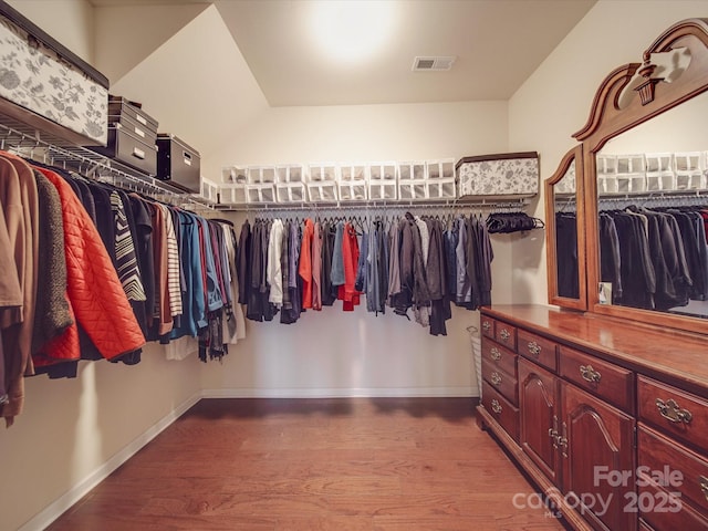 walk in closet with wood-type flooring