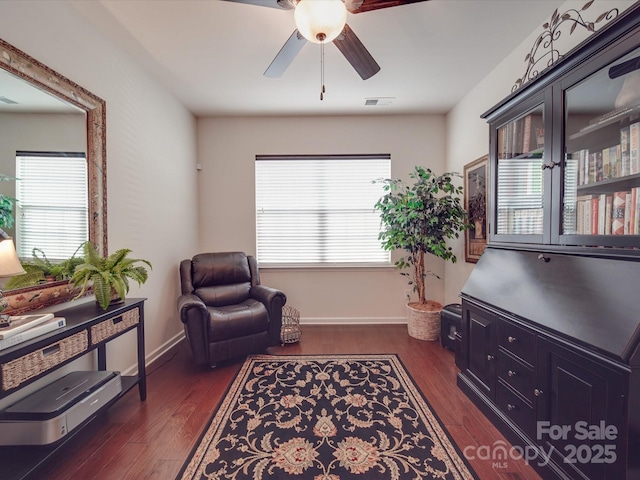 sitting room featuring dark hardwood / wood-style floors, a wealth of natural light, and ceiling fan