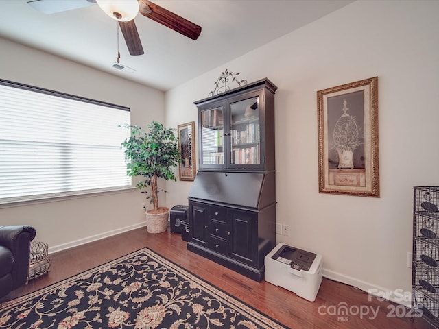 sitting room featuring dark hardwood / wood-style floors and ceiling fan