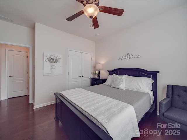 bedroom featuring dark hardwood / wood-style flooring, a closet, and ceiling fan