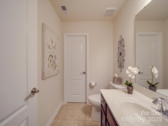 bathroom with vanity, tile patterned floors, and toilet