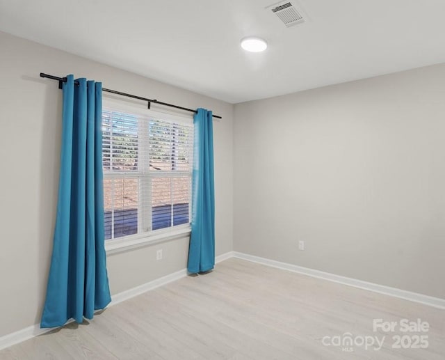 empty room with light hardwood / wood-style flooring