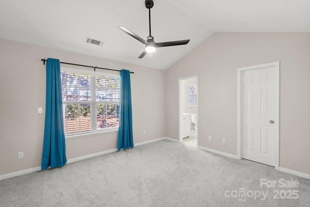 empty room featuring ceiling fan, light colored carpet, and lofted ceiling