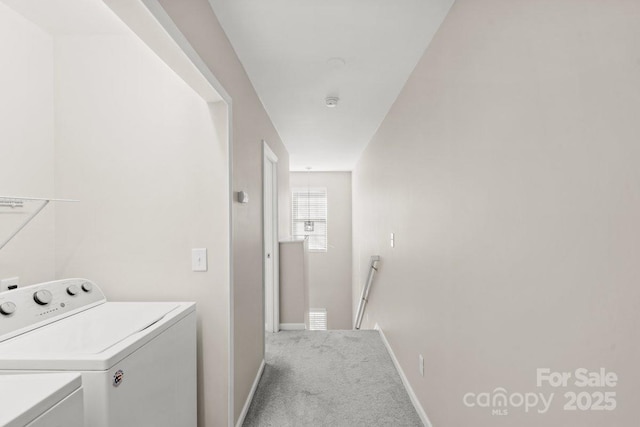 clothes washing area featuring washer and clothes dryer and carpet floors