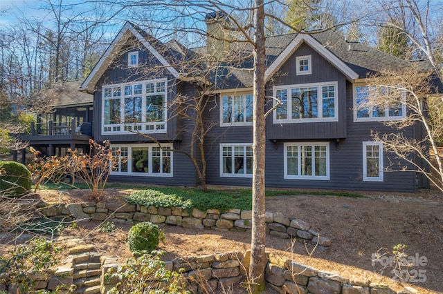 back of house featuring a sunroom