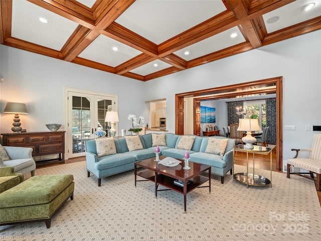 carpeted living room featuring a towering ceiling, french doors, an inviting chandelier, beamed ceiling, and coffered ceiling