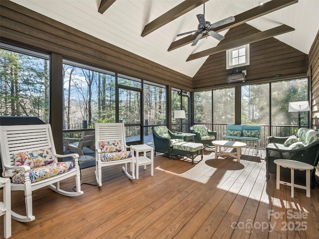 sunroom with ceiling fan, vaulted ceiling with beams, and plenty of natural light