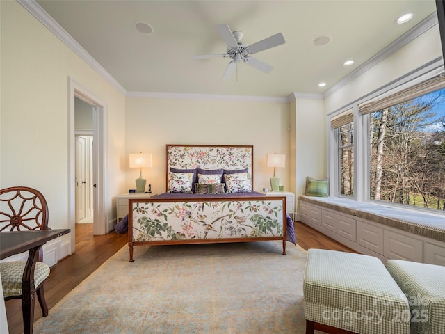 bedroom with ceiling fan, dark wood-type flooring, and crown molding