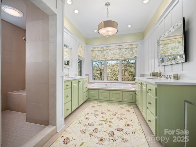 bathroom with a tub to relax in, tile patterned floors, and vanity