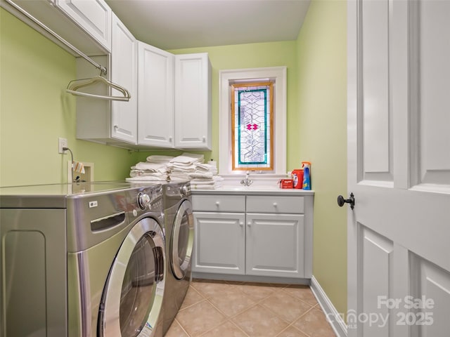 laundry room with sink, light tile patterned flooring, separate washer and dryer, and cabinets