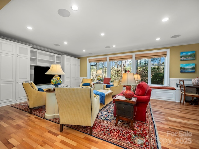 living room featuring crown molding and light hardwood / wood-style floors