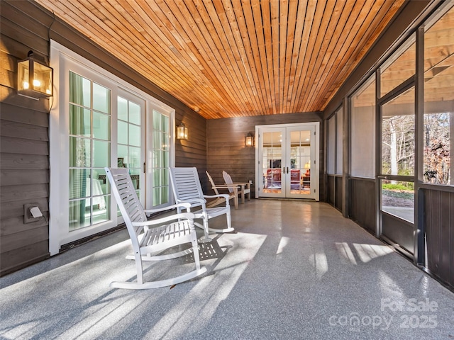 unfurnished sunroom featuring wooden ceiling and french doors