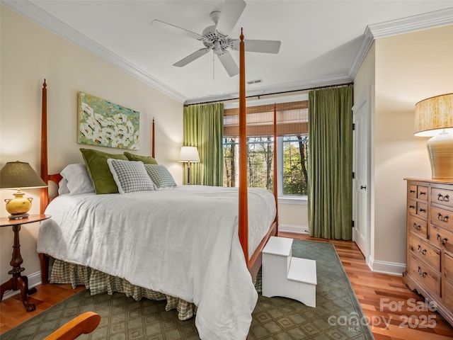 bedroom with ceiling fan, ornamental molding, and hardwood / wood-style floors