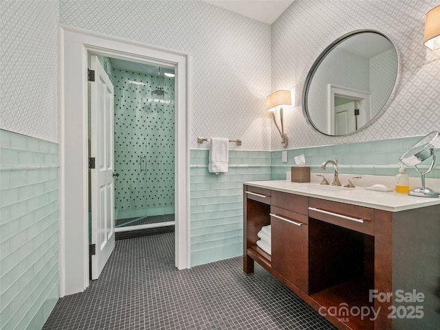 bathroom featuring a shower, vanity, and tile patterned flooring