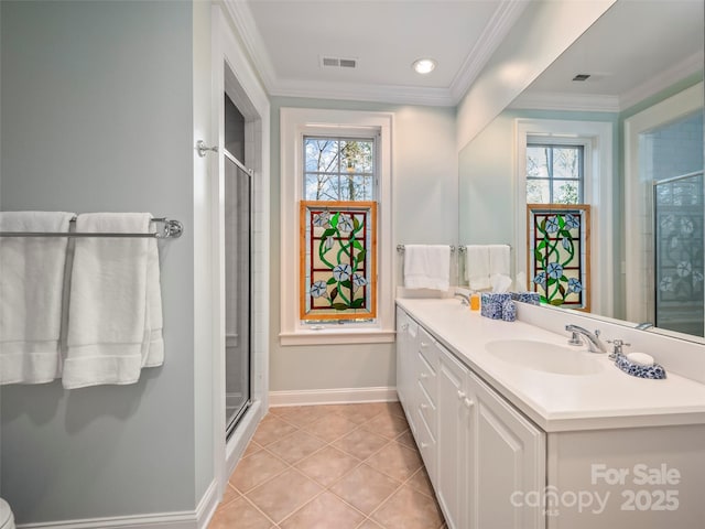 bathroom with walk in shower, crown molding, vanity, and tile patterned flooring