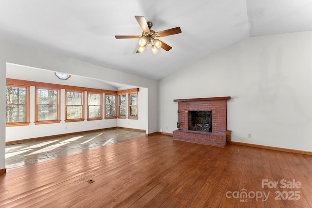 550 Kinross Dr, Flat Rock, NC 28731 - unfurnished living room featuring ceiling fan, vaulted ceiling, a brick fireplace, and wood-type flooring