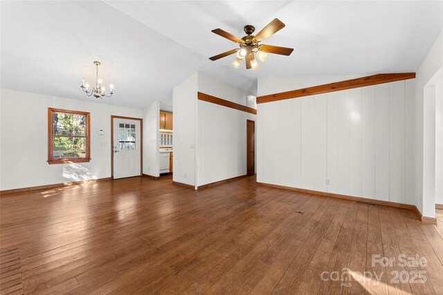 550 Kinross Dr, Flat Rock, NC 28731 - unfurnished living room featuring vaulted ceiling, ceiling fan with notable chandelier, and dark hardwood / wood-style floors