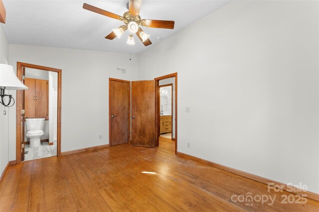 550 Kinross Dr, Flat Rock, NC 28731 - unfurnished bedroom with ceiling fan, ensuite bathroom, lofted ceiling, and light hardwood / wood-style floors