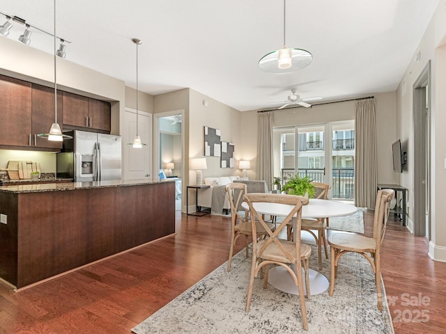 dining space featuring dark wood-type flooring and ceiling fan